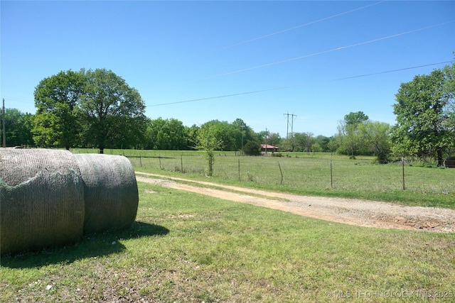 view of yard with a rural view and fence