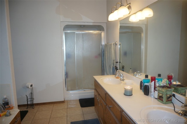 bathroom featuring a shower stall, tile patterned floors, a sink, and double vanity