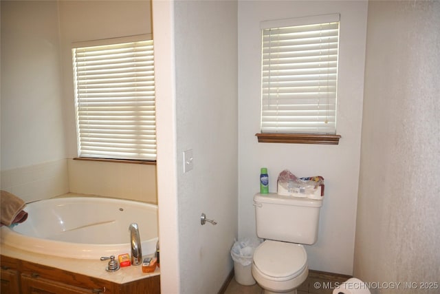 bathroom with a garden tub and toilet