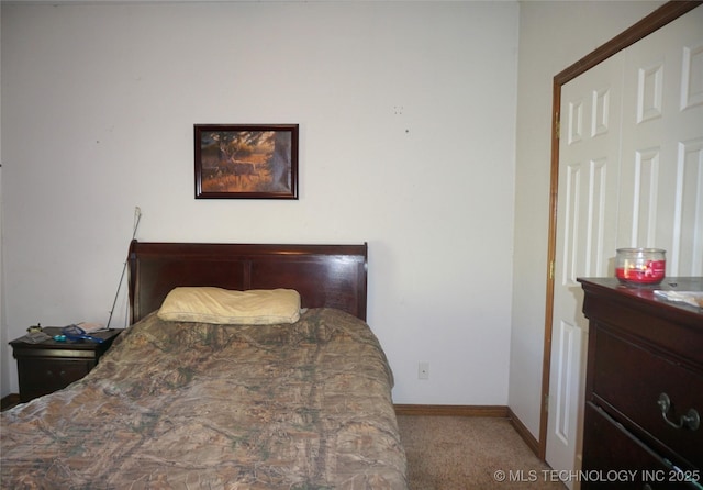 carpeted bedroom with baseboards