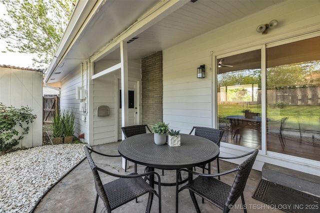 view of patio featuring outdoor dining space and fence