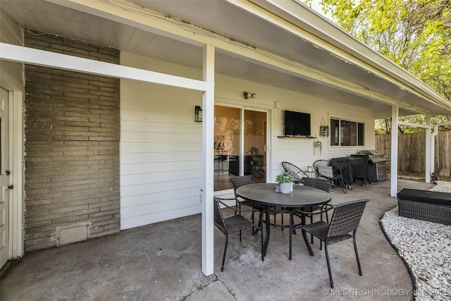 view of patio / terrace featuring outdoor dining area, a grill, and fence