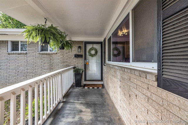 doorway to property featuring brick siding
