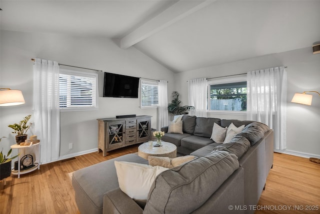 living area with light wood finished floors, vaulted ceiling with beams, and baseboards