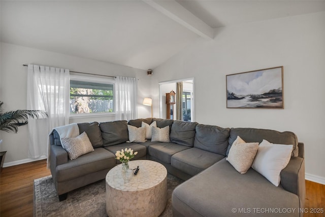 living area featuring wood finished floors, baseboards, and lofted ceiling with beams