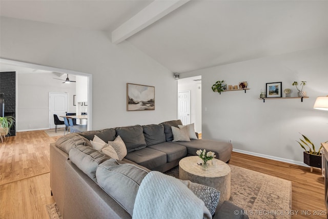 living room featuring baseboards, a ceiling fan, vaulted ceiling with beams, and light wood-style flooring