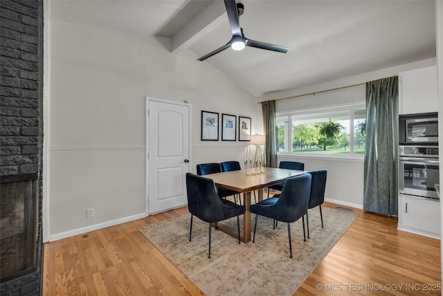 dining area with wood finished floors, lofted ceiling with beams, ceiling fan, baseboards, and visible vents