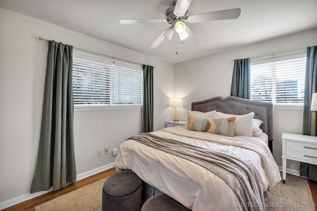 bedroom with ceiling fan, baseboards, and wood finished floors
