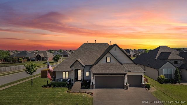 18510 E 46th Pl S, Tulsa, OK 74134 - french country style house featuring an attached garage, driveway, a residential view, and a shingled roof
