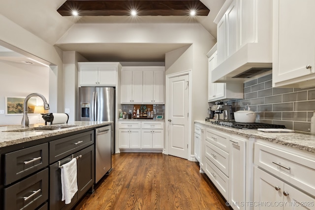 18510 E 46th Pl S, Tulsa, OK 74134 - kitchen with a sink, stainless steel appliances, premium range hood, white cabinetry, and lofted ceiling