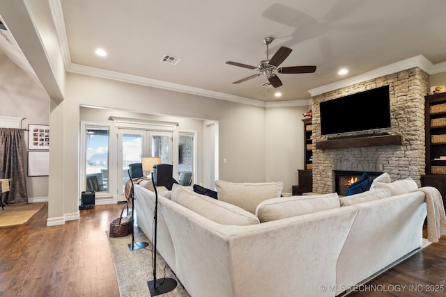 18510 E 46th Pl S, Tulsa, OK 74134 - living area featuring crown molding, ceiling fan, a stone fireplace, wood finished floors, and baseboards