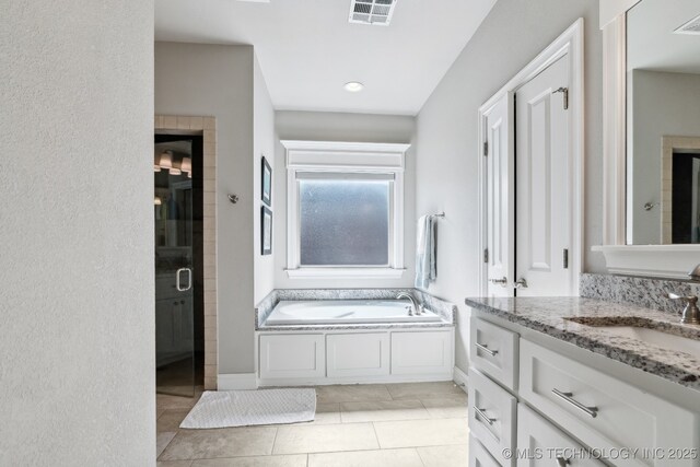 18510 E 46th Pl S, Tulsa, OK 74134 - full bathroom with vanity, a garden tub, a shower stall, and tile patterned flooring