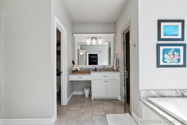 18510 E 46th Pl S, Tulsa, OK 74134 - full bathroom featuring vanity, a stall shower, toilet, a chandelier, and baseboards