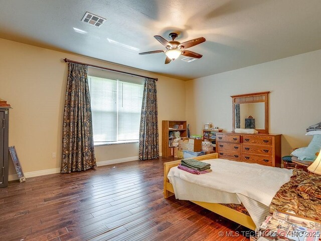 21125 State Highway 99 S, Stonewall, OK 74871 - bedroom featuring baseboards, wood finished floors, visible vents, and ceiling fan