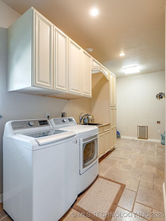 21125 State Highway 99 S, Stonewall, OK 74871 - washroom featuring washer and clothes dryer, a sink, stone tile flooring, cabinet space, and recessed lighting