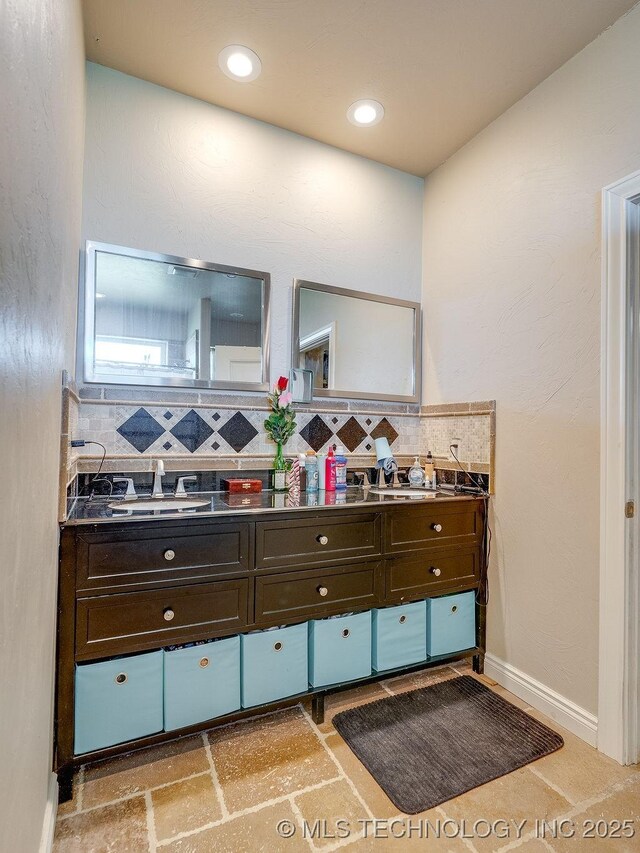 21125 State Highway 99 S, Stonewall, OK 74871 - bathroom with double vanity, tasteful backsplash, baseboards, and a sink