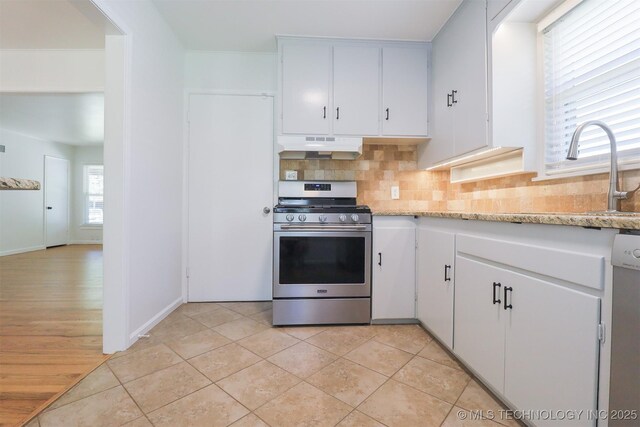 4335 S Cincinnati Ave, Tulsa, OK 74105 - kitchen featuring stainless steel appliances, under cabinet range hood, decorative backsplash, and white cabinetry