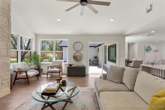 living room with visible vents, recessed lighting, lofted ceiling, wood finished floors, and ceiling fan