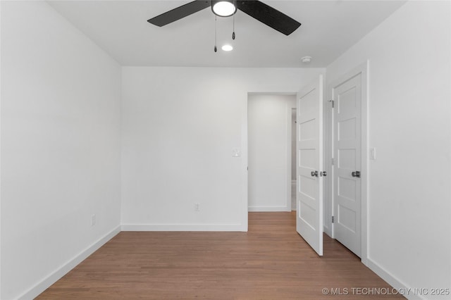 unfurnished bedroom featuring baseboards, a ceiling fan, and wood finished floors