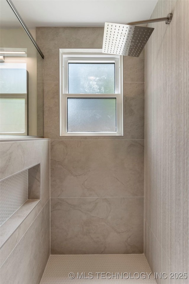full bath featuring a tile shower