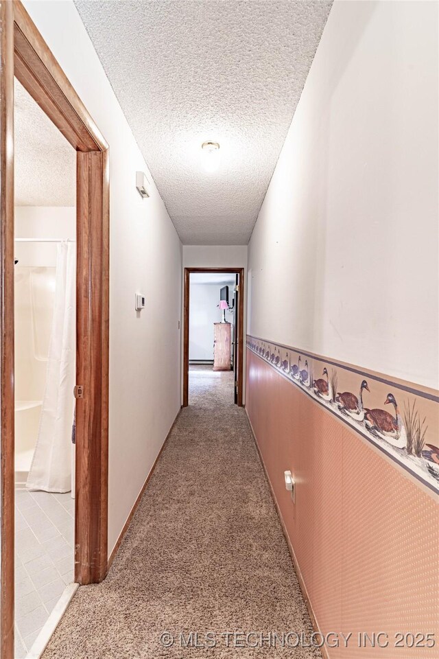 2445 E 156th St N, Skiatook, OK 74070 - hall with carpet and a textured ceiling