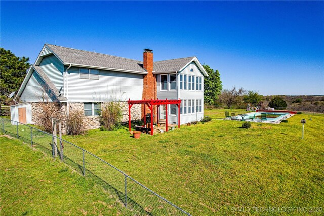 2445 E 156th St N, Skiatook, OK 74070 - back of property featuring a fenced in pool, a chimney, fence, stone siding, and a lawn