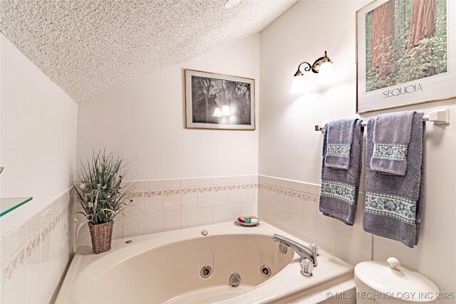 2445 E 156th St N, Skiatook, OK 74070 - bathroom with vaulted ceiling, toilet, a whirlpool tub, and a textured ceiling