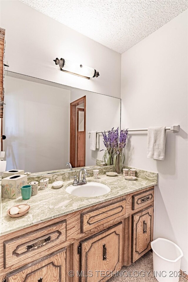 2445 E 156th St N, Skiatook, OK 74070 - bathroom with a textured ceiling and vanity