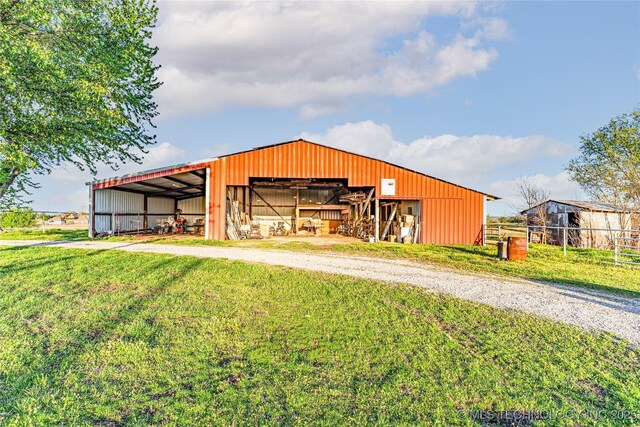 2445 E 156th St N, Skiatook, OK 74070 - view of pole building with a lawn, fence, and driveway