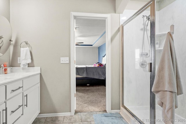 7201 S Joshua Ave, Broken Arrow, OK 74011 - bathroom featuring tile patterned floors, baseboards, a shower stall, vanity, and connected bathroom