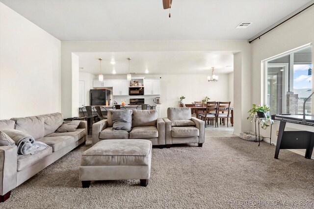 7201 S Joshua Ave, Broken Arrow, OK 74011 - living room with light carpet, visible vents, and a notable chandelier