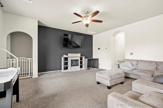 7201 S Joshua Ave, Broken Arrow, OK 74011 - living area with visible vents, a ceiling fan, carpet flooring, and arched walkways