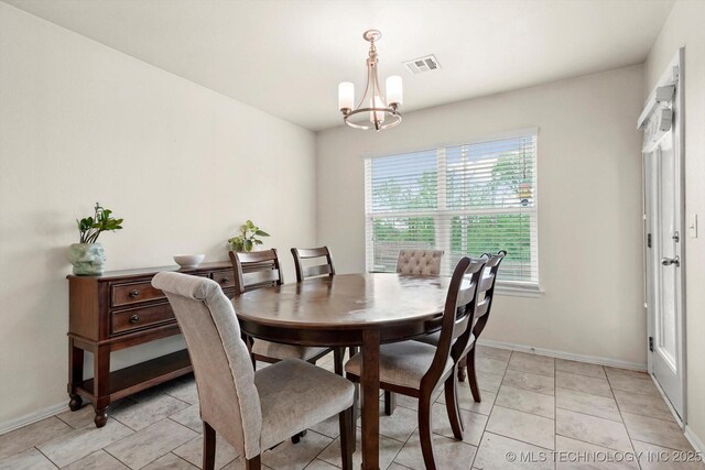 7201 S Joshua Ave, Broken Arrow, OK 74011 - dining area featuring baseboards, visible vents, and a notable chandelier