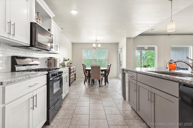 7201 S Joshua Ave, Broken Arrow, OK 74011 - kitchen featuring plenty of natural light, a sink, backsplash, and black appliances