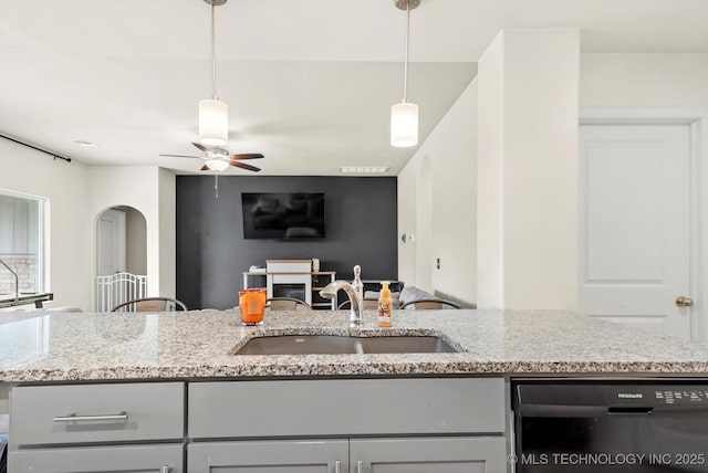 7201 S Joshua Ave, Broken Arrow, OK 74011 - kitchen featuring a ceiling fan, light stone counters, a sink, open floor plan, and black dishwasher