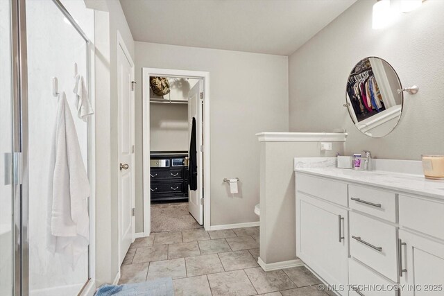 7201 S Joshua Ave, Broken Arrow, OK 74011 - full bathroom featuring a shower stall, toilet, a walk in closet, and vanity