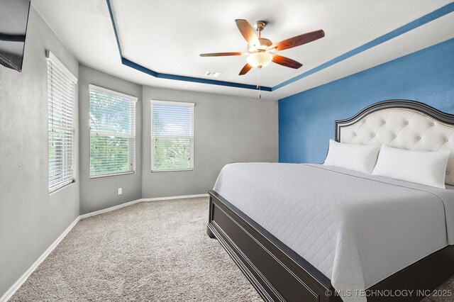 7201 S Joshua Ave, Broken Arrow, OK 74011 - bedroom with ceiling fan, a tray ceiling, visible vents, baseboards, and carpet floors