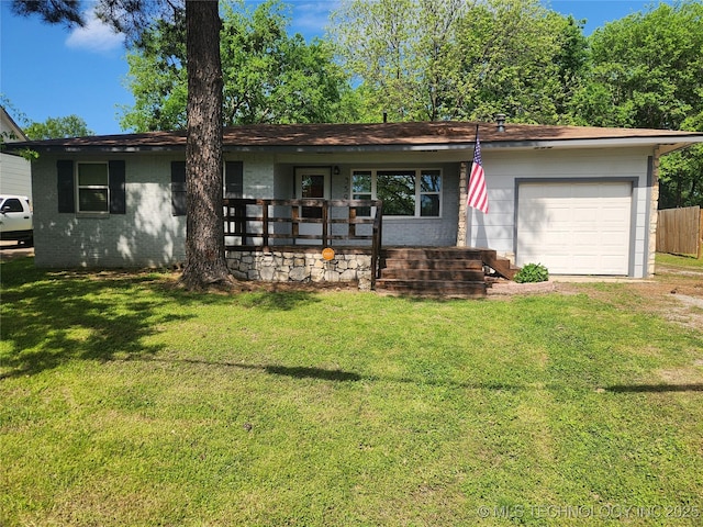 single story home with a porch, an attached garage, a front lawn, and brick siding