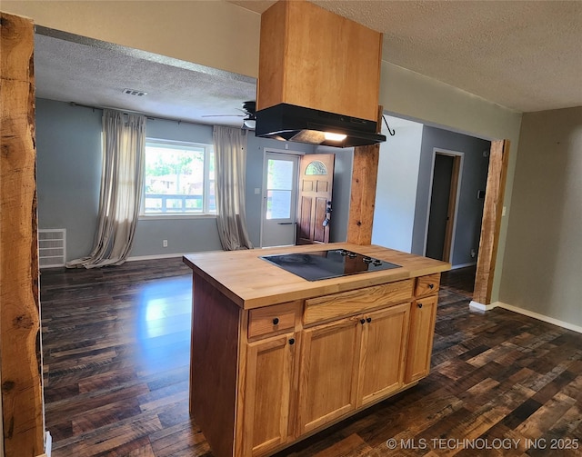 kitchen featuring black electric cooktop, a textured ceiling, dark wood-style flooring, under cabinet range hood, and wooden counters
