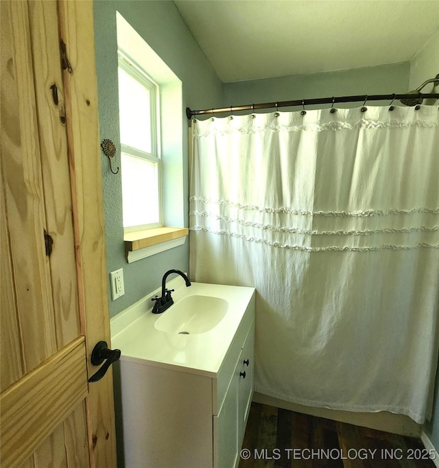 bathroom with vanity and curtained shower