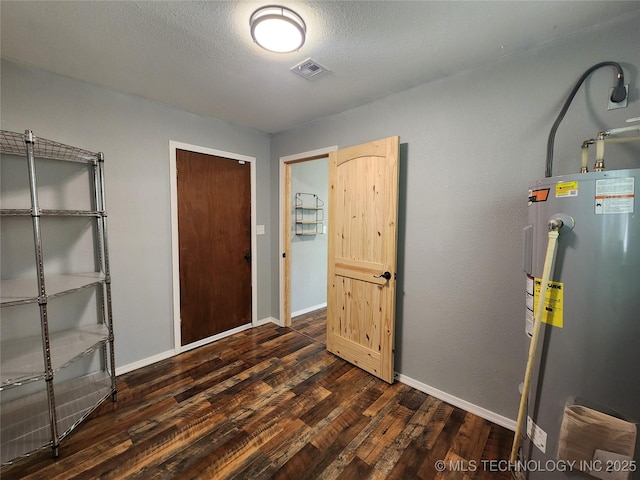 utility room with water heater and visible vents