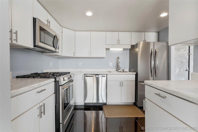 450 W 7th St Unit 1902, Tulsa, OK 74119 - kitchen featuring light stone counters, a sink, white cabinetry, and appliances with stainless steel finishes