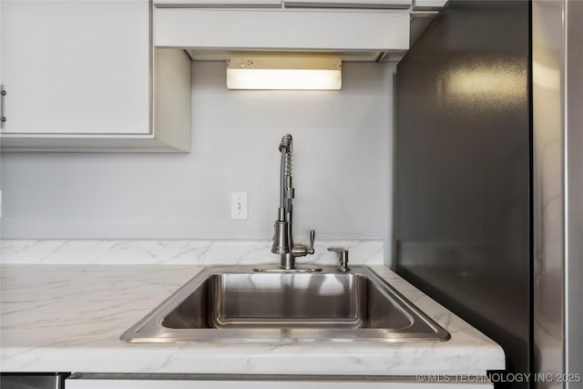 450 W 7th St Unit 1902, Tulsa, OK 74119 - room details featuring light stone countertops, freestanding refrigerator, and a sink