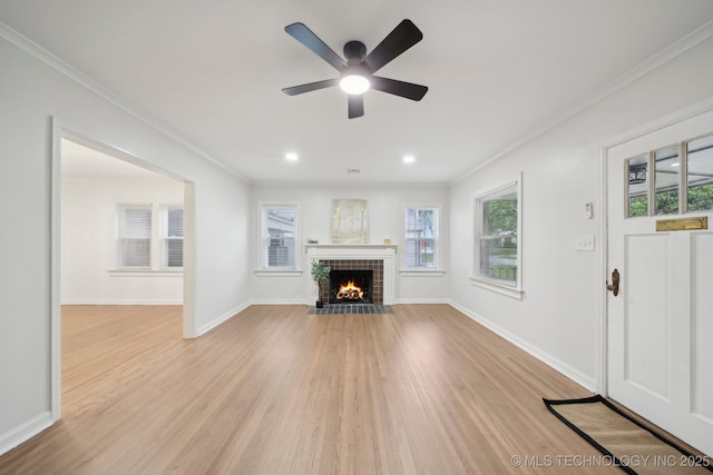 1136 S Evanston Ave, Tulsa, OK 74104 - unfurnished living room with light wood-style flooring, crown molding, a fireplace with flush hearth, a ceiling fan, and baseboards
