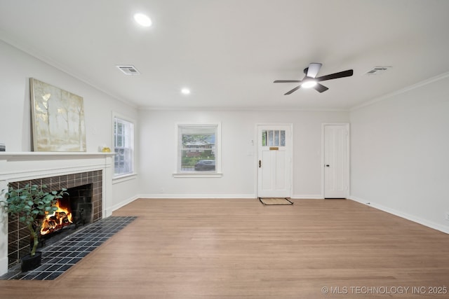 1136 S Evanston Ave, Tulsa, OK 74104 - unfurnished living room featuring crown molding, wood finished floors, a tile fireplace, a ceiling fan, and baseboards
