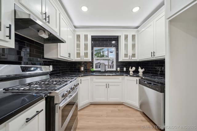 1136 S Evanston Ave, Tulsa, OK 74104 - kitchen with stainless steel appliances, under cabinet range hood, a sink, white cabinets, and recessed lighting
