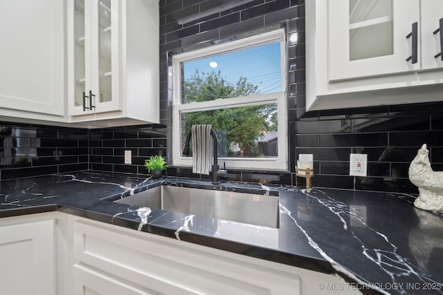 1136 S Evanston Ave, Tulsa, OK 74104 - kitchen featuring a sink, white cabinetry, tasteful backsplash, and glass insert cabinets