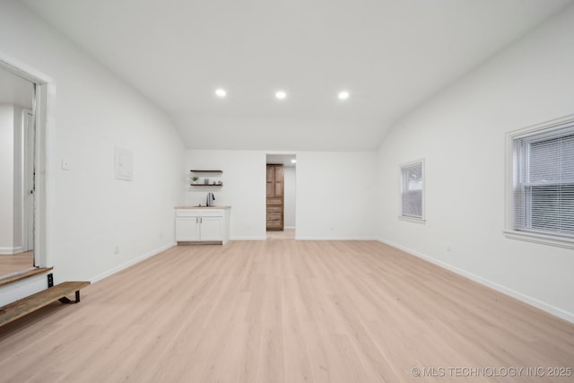 1136 S Evanston Ave, Tulsa, OK 74104 - unfurnished living room with lofted ceiling, light wood-type flooring, recessed lighting, and baseboards