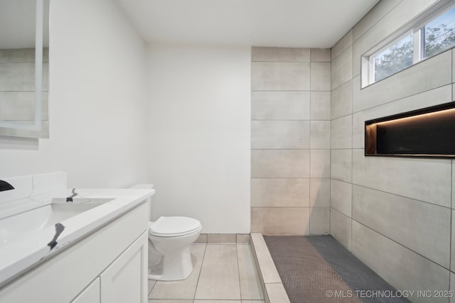 1136 S Evanston Ave, Tulsa, OK 74104 - full bathroom with vanity, toilet, and tile patterned floors