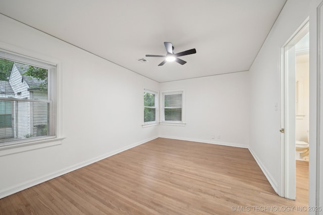 1136 S Evanston Ave, Tulsa, OK 74104 - empty room with healthy amount of natural light, light wood-style floors, and ceiling fan